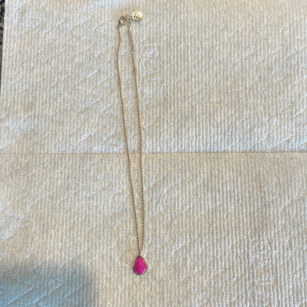 Kendra Scott short necklace with pink pendant.